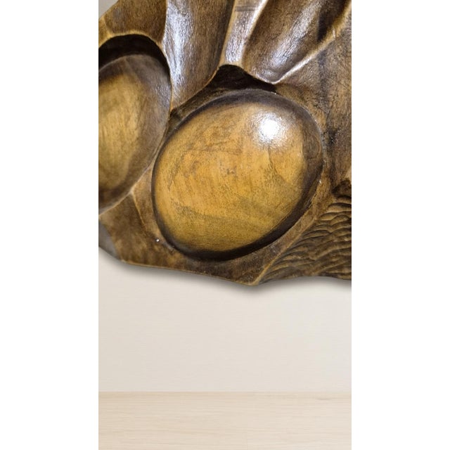 A distinctive mid-century carved wooden wall panel featuring an abstract organic relief composition with rounded forms,...