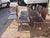 Vintage Mid-Century Modern dining chairs featuring sculptural bentwood seats and backs in a rich dark wood finish. The...