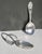 Two spoons for the baby. One short handle with a teddy bear design and the other with a pierced pattern on the curled...