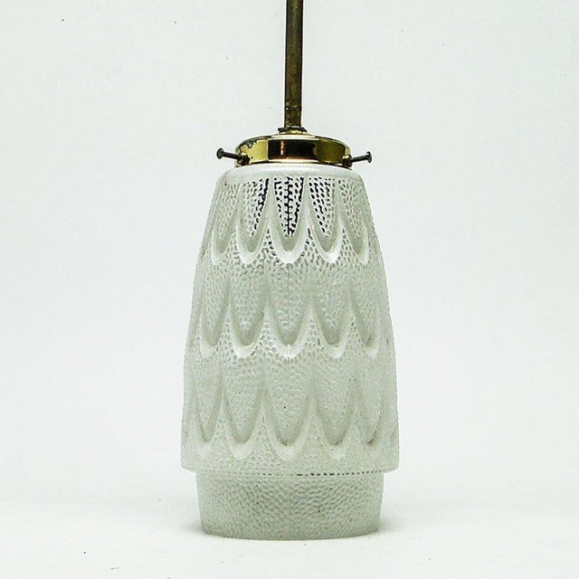 The pendant lamp was produced in the 50s. The construction is brass, glass lampshade. It is preserved in very good...
