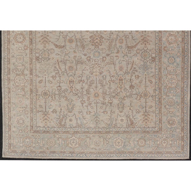 Measures: 9'10 x 13'8 Afghanistan Tabriz Rug in Pale Sand, Brown, and Blue with Floral Medallion. Keivan Woven Arts/...