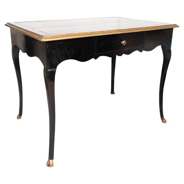 Early Louis XV Ebonized Writing Table rectangular top with inset reddish-brown leather and gilded outer edge. The frieze...