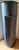A rustic, single-door corner cabinet with a gently curved (bow) front, retaining its original blue painted surface over an...