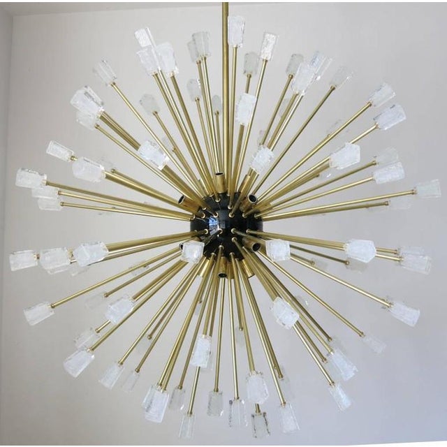 Modern Italian Sputnik chandelier composed of 96 unique clear Murano glass cubes blown in Pulegoso technique to provide an...