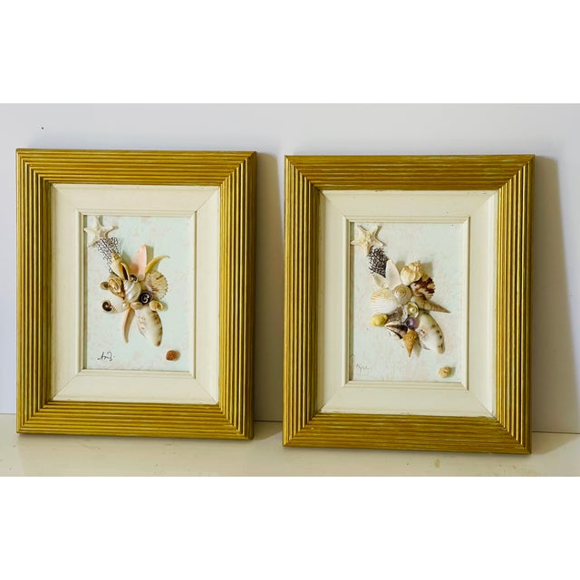 Original signed pair of artist sea shell composition installations framed gold tone painted frames. Great coastal decor...