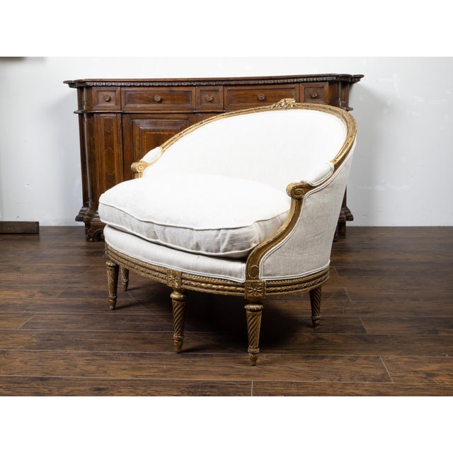 A French Louis XVI style giltwood canapé en corbeille from the 19th century, with carved flowers and new upholstery....