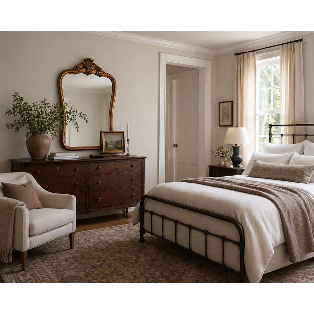 A beautifully proportioned antique wall mirror featuring an elegant Rococo-inspired giltwood frame with a richly carved...