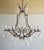 Monumental (10) light beaded wrought iron & rock crystal chandelier. The chandelier is adorned with garlands of beads and...