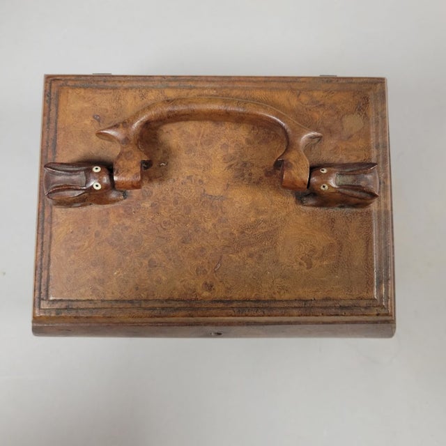 A finely made Victorian burl walnut decorative box featuring an unusual carved rabbit handle, circa 1880. Two sculpted...