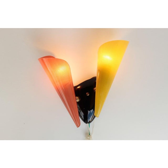 Colorful wall lamp with movable lampshades, made in the 1950s. Brass, acrylic glass, plastic. Very good condition, slight...