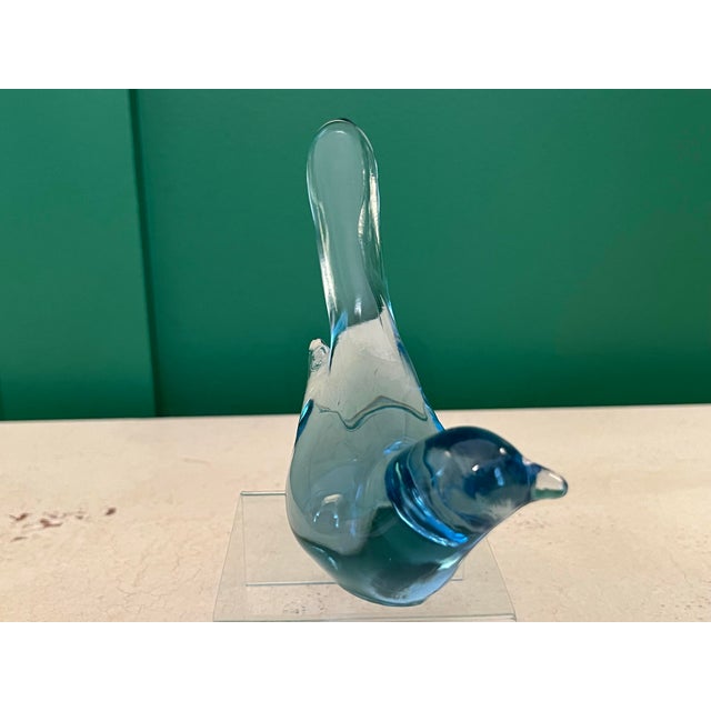 A beautiful glass bird in a rare aquamarine color. It is stamped Fenton #9.
