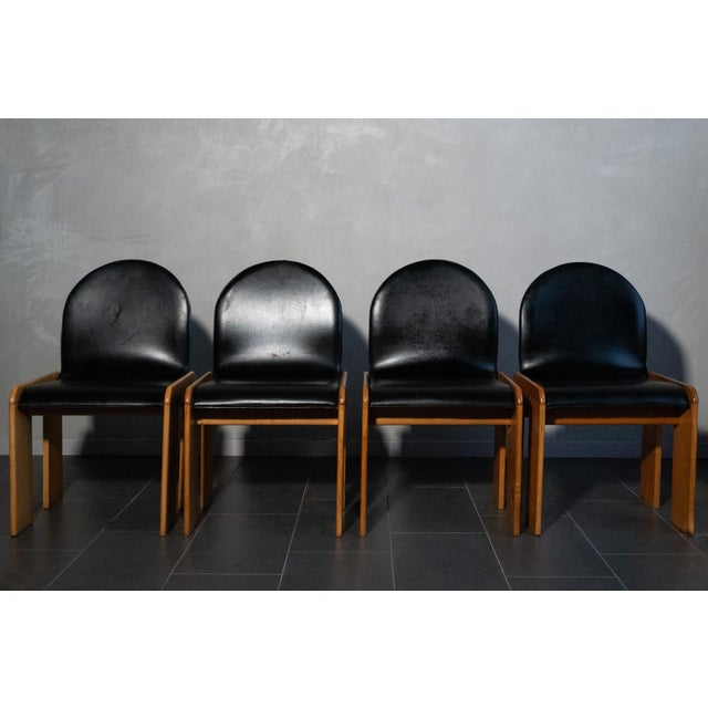 Set of four chairs attributed to Afra and Tobia Scarpa, in larch and original black vinyl, filled over the years as shown...