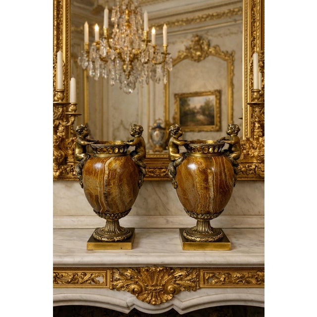 A superb pair of 19th-century cassolettes, crafted in the Louis XVI style, from finely chased bronze and alabaster with...