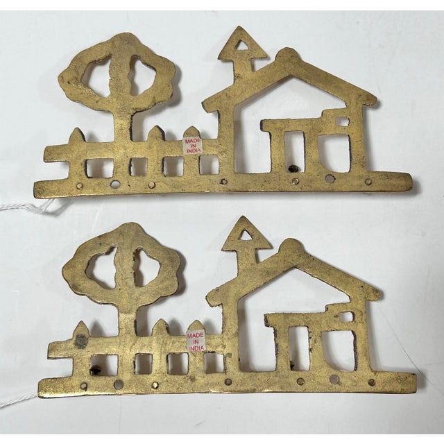 Mid Century, solid brass wall hanging for keys. They feature a brass outline of a house, tree and fence with 5 hooks along...