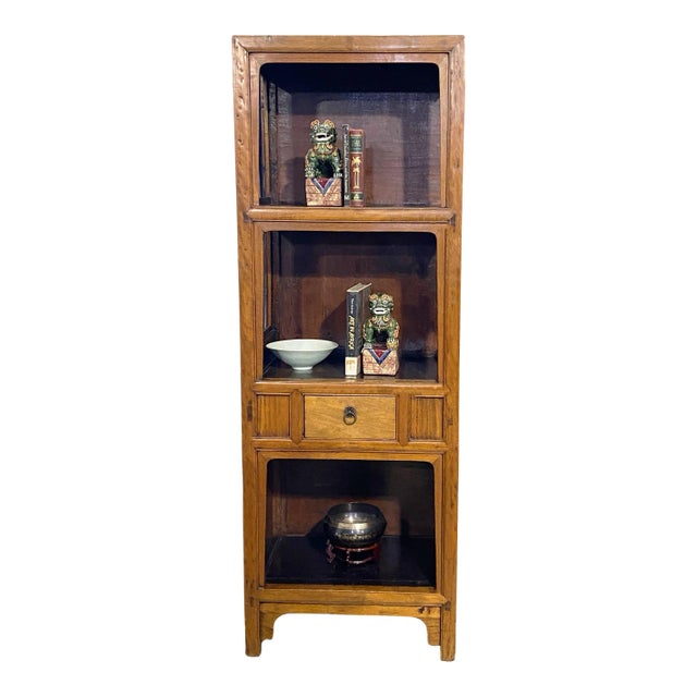 This Vintage Mid Century Chinoiserie Cantonese Elm Wood Etagere Bookcase is in good condition, with minimal signs of wear...