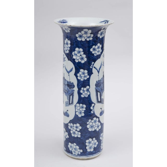 Chinese blue and white straight vase with flared neck decorated with the “100 Antiques” pattern within two shield-shapes,...
