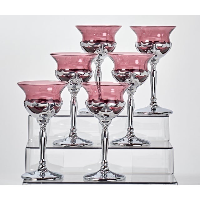 Elegant art deco drink ware. Slender stems hold traditional shaped goblet glass.