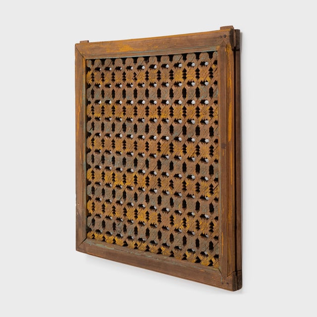 This antique lattice window panel from the early 20th century likely originated in a northern Chinese home with neutral...