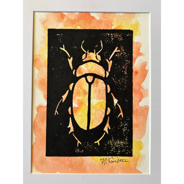 An original hand-carved block linocut featuring a detailed beetle motif, individually printed with black ink and finished...
