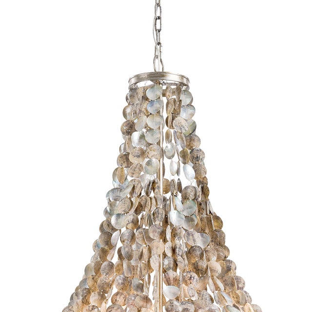 Pieces of abalone shell look iridescently cool in this chandelier, providing dimension and a hint of shine. The shells...