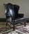 Great high quality early Kittinger Chippendale Style wing chair. Black leather with black nailheads. The design was a...