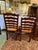 This is a pair of ladder back chairs in a dark wood finish. They are intentionally two different heights: one for the...