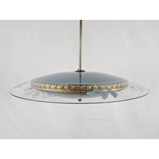 Elegant '40 chandelier in glass with various processes and floral theme decorations. Main structure and brass edge also...