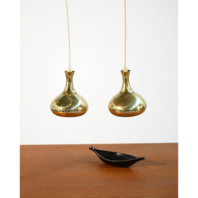 Perforated brass ceiling lamps with an organic profile and dotted light diffusion. Attributed to Hans-Agne Jakobsson for...
