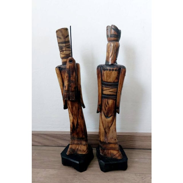 An exceptional pair of finely carved Chinese figures in ox bone, depicting the legendary strategist Jiang Taigong and the...