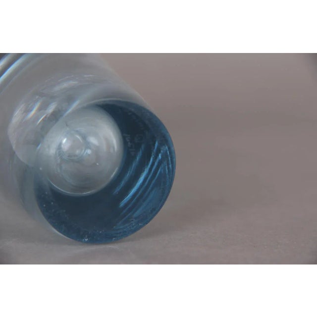 A beautiful mouth-blown Holmegaard vase. Design by Per Lütken. Light blue transparent glass. Signature below the bottom...