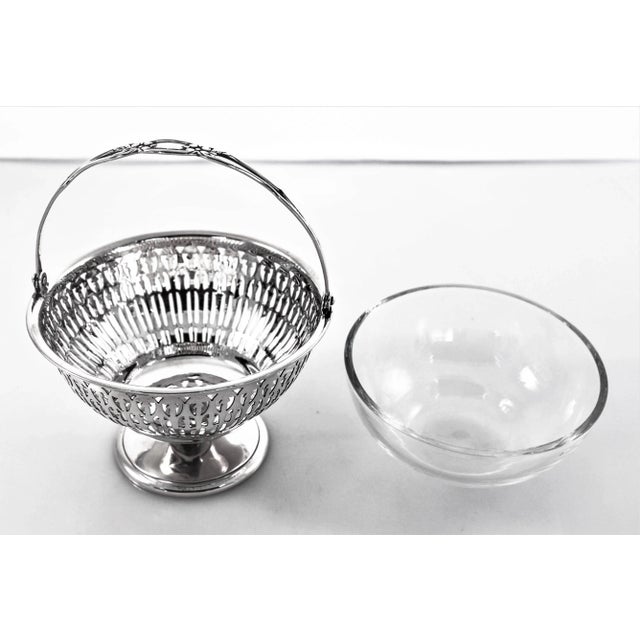 An elegant cutout design encircles the entire basket. It sits on a non weighted pedestal. The handle folds down for easy...