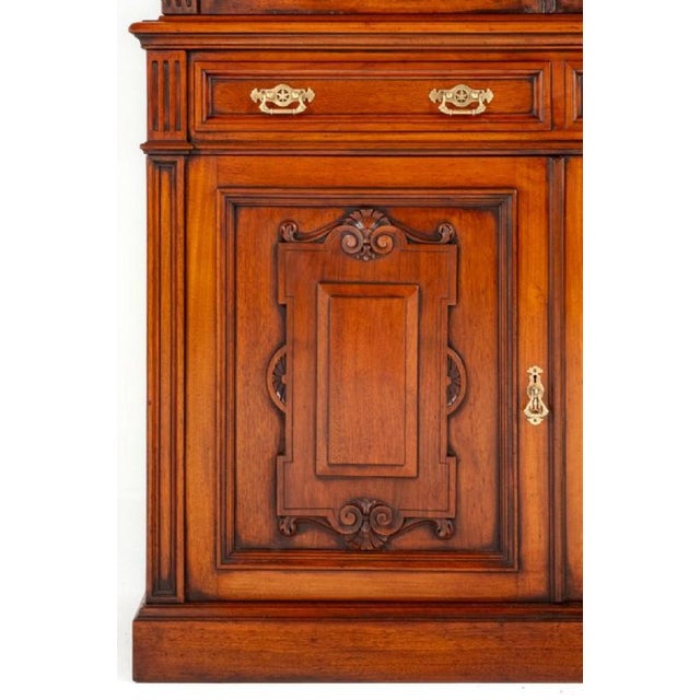 Victorian Walnut 3 Door Glazed Bookcase. Circa 1880 This Bookcase Stands Upon a Plinth Base. The 3 Lower Doors Featuring...