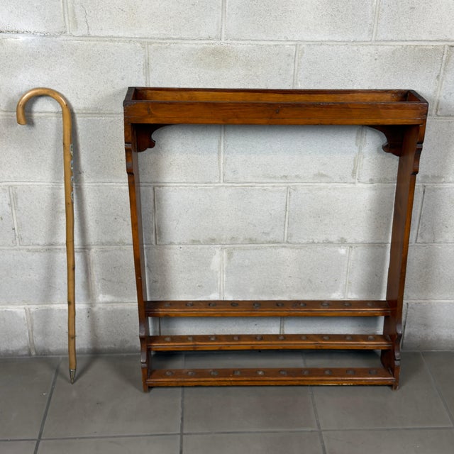 A distinctive and functional solid wood display stand, ideal for storing and displaying collectible walking sticks,...