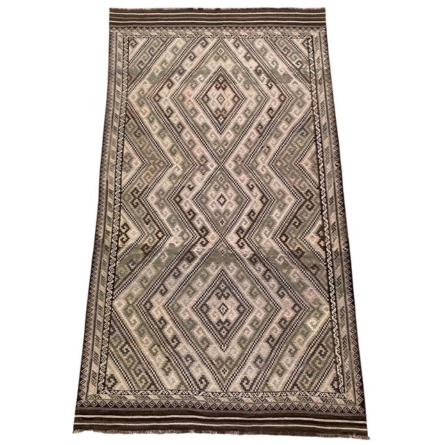 A large handwoven Maimana kilim from northern Afghanistan, in the natural fleece tones the region is known for — oatmeal...