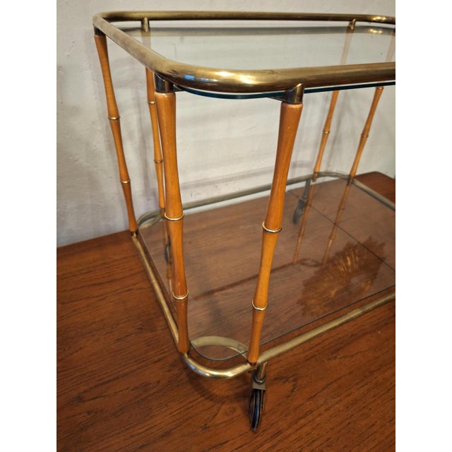 Mid century finely-shaped serving trolley in brass with faux bamboo supports, 1950s-1960s. Beautifully patinated brass. A...