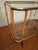 Mid century finely-shaped serving trolley in brass with faux bamboo supports, 1950s-1960s. Beautifully patinated brass. A...