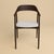 The Mikura is an upholstered oak chair, a seat with a gently curved back and slender lines in Dedar Melange Modern set on...