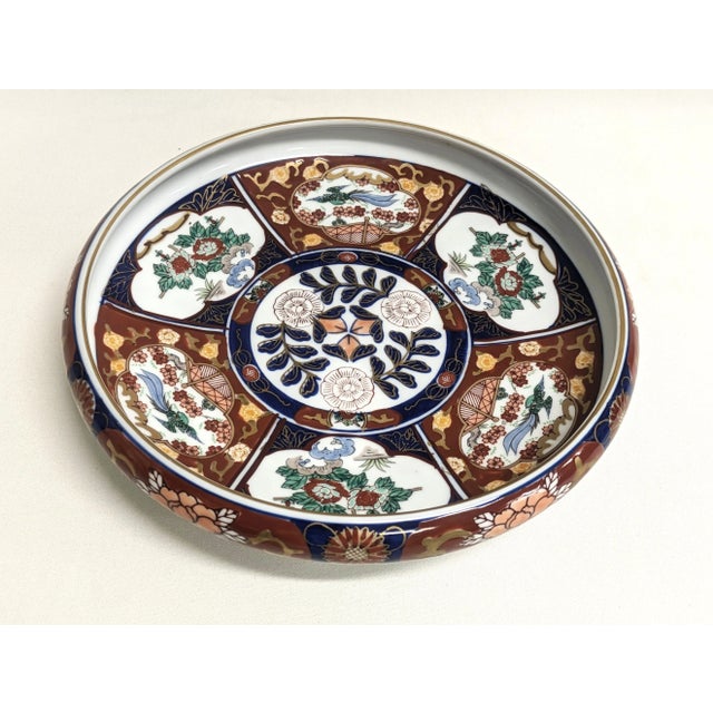 A large (9.5") Gold Imari porcelain bowl by Otagiri Japan. The vintage platter features hand-painted floral designs of...