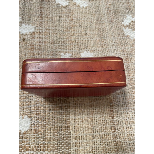 Listed is a vintage Italian burgundy leather box with an embossed gold fleur-de-lis design. It is a storage box perfect...