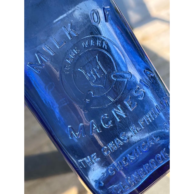 Add a striking pop of vivid color to your decor with this vintage cobalt blue glass Milk of Magnesia bottle. Produced by...
