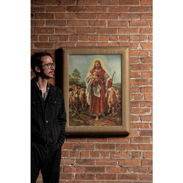 A mid-century illuminated devotional artwork depicting Christ as the Good Shepherd, rendered in warm, painterly tones and...