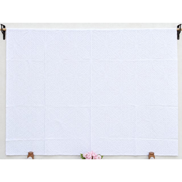 A lightweight cotton coverlet from Western India, beautifully adorned with intricate handcrafted appliqué cutwork. The...