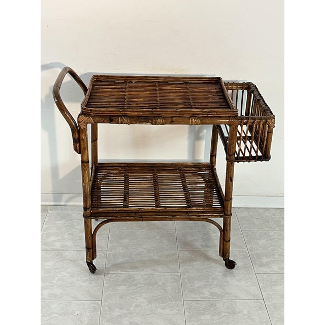 Made in Italy bamboo bar trolley in the 1950s Detail for the protruding bottle holder. Intact and in good condition. Small...