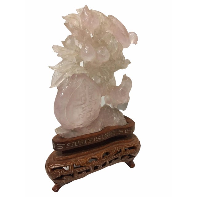 Beautiful Chinese carved rose quartz sculpture depicting several birds set on a fitted wood base.