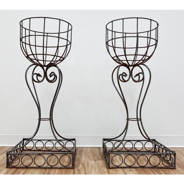 Vintage French Art Nouveau style jardiniere plant stands. Wrought iron stands feature original patina. Bowls are supported...