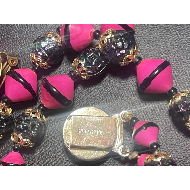 A double strand 20” necklace with matching cluster clip on earrings with lava rock beads. These distinct elements are made...