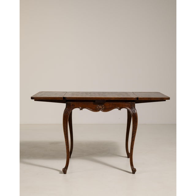 Rendered in the refined spirit of the Louis XV period, this exquisite expanding side table from mid-twentieth-century...