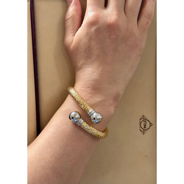 This exquisite vintage cuff bangle bracelet showcases two colors of gold elegant 18 karat solid yellow & White gold. The...