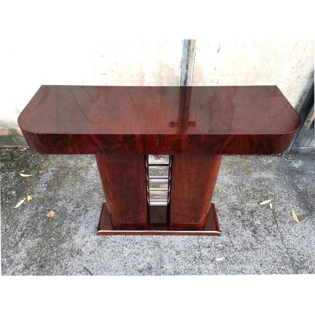 An elegant French Art Deco console table from the 1930s, featuring a beautifully crafted, architectural design. The piece...