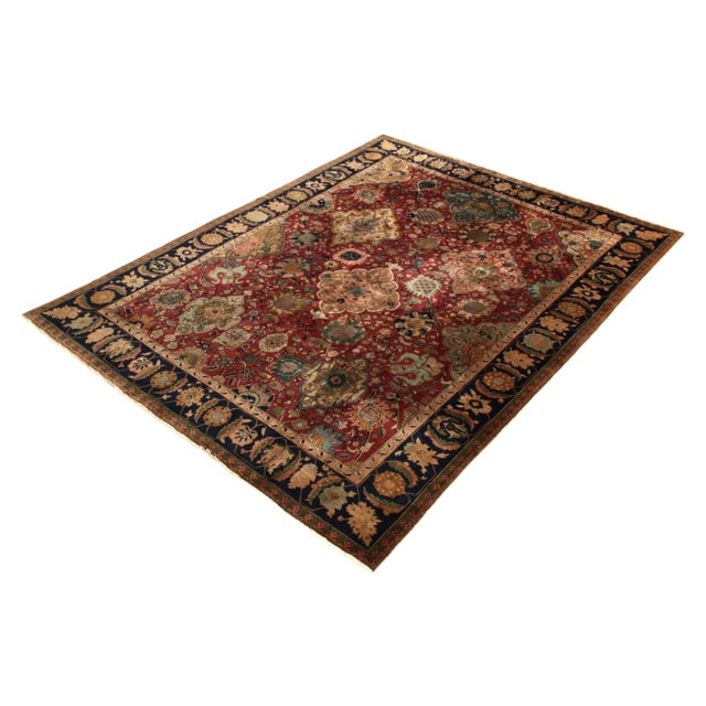 Hand knotted in wool originating from Nepal circa 1910-1920, this 9x12 antique rug connotes a Shahrestan rug design of...